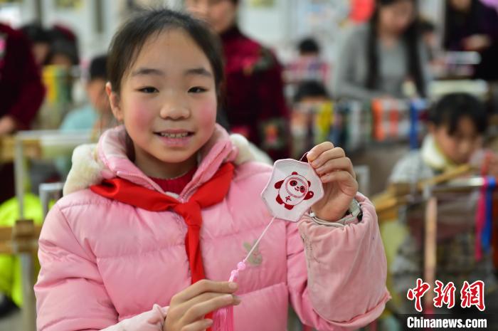 圖為一名小學(xué)生繡制的2022年北京冬奧會(huì)吉祥物“冰墩墩”形象。　喻云亮 攝