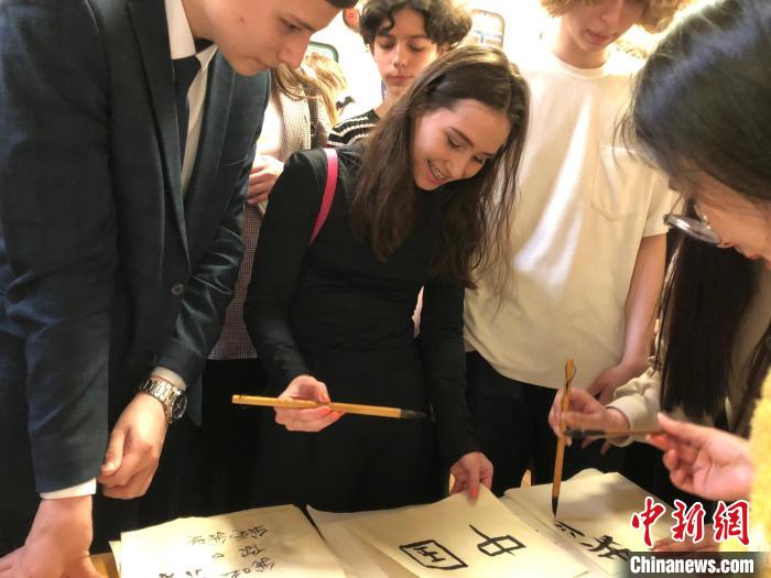 4月21日，莫斯科國(guó)立語(yǔ)言大學(xué)孔子學(xué)院附屬中學(xué)舉辦“國(guó)際中文日”活動(dòng)，學(xué)生們學(xué)寫(xiě)漢字?！∧箍茋?guó)立語(yǔ)言大學(xué)孔子學(xué)院 供圖