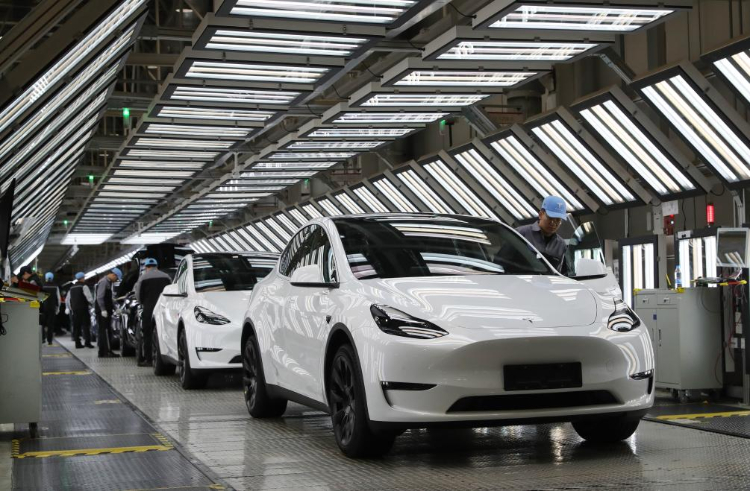 2023年12月22日，在特斯拉上海超級工廠內(nèi)，工人在對出廠前的車輛進行漆面及門窗檢測。新華社記者 方喆 攝