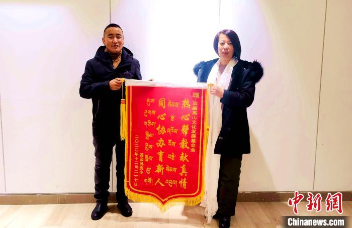 圖為聶榮縣完全小學(xué)向西藏高山文化發(fā)展基金會贈送錦旗。　于賓 攝