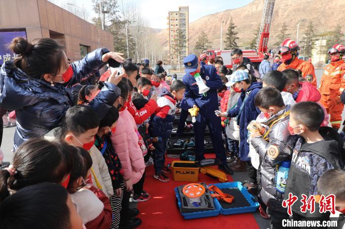 圖為小朋友們聽消防員講解消防器材?！铨埥?攝