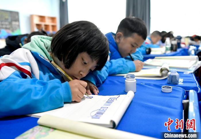 3月14日，西藏拉薩市第一小學一年級六班的學生們在藏語文課上書寫藏文。　李林 攝