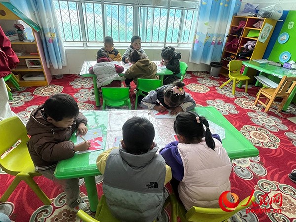 拉多村一所現(xiàn)代化幼兒園小班孩子們正在繪畫。張敏穎 攝